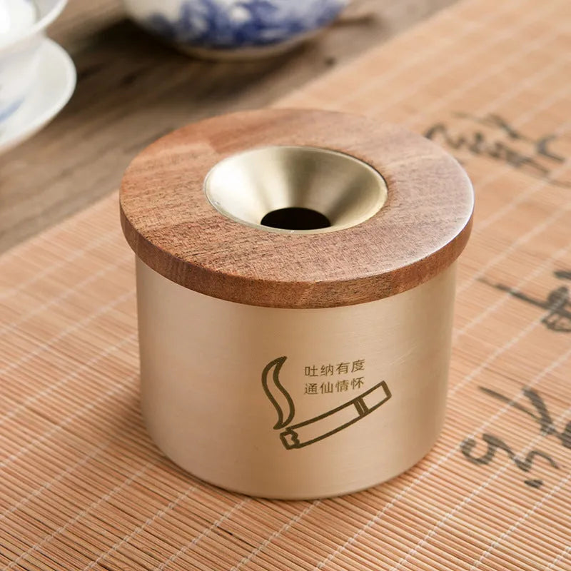 Brass ashtray with wooden lid showing centre hole design and copper construction