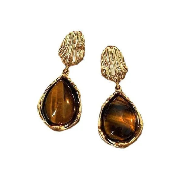 Three pairs of geometric holiday earrings with tassel accents in electroplated alloy