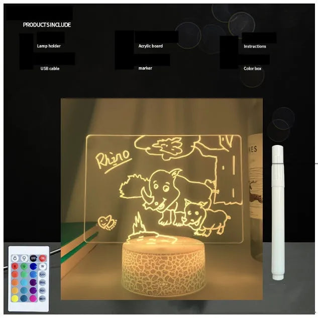 3D acrylic message board LED lamp lit up on a desk with remote control and marker pen.