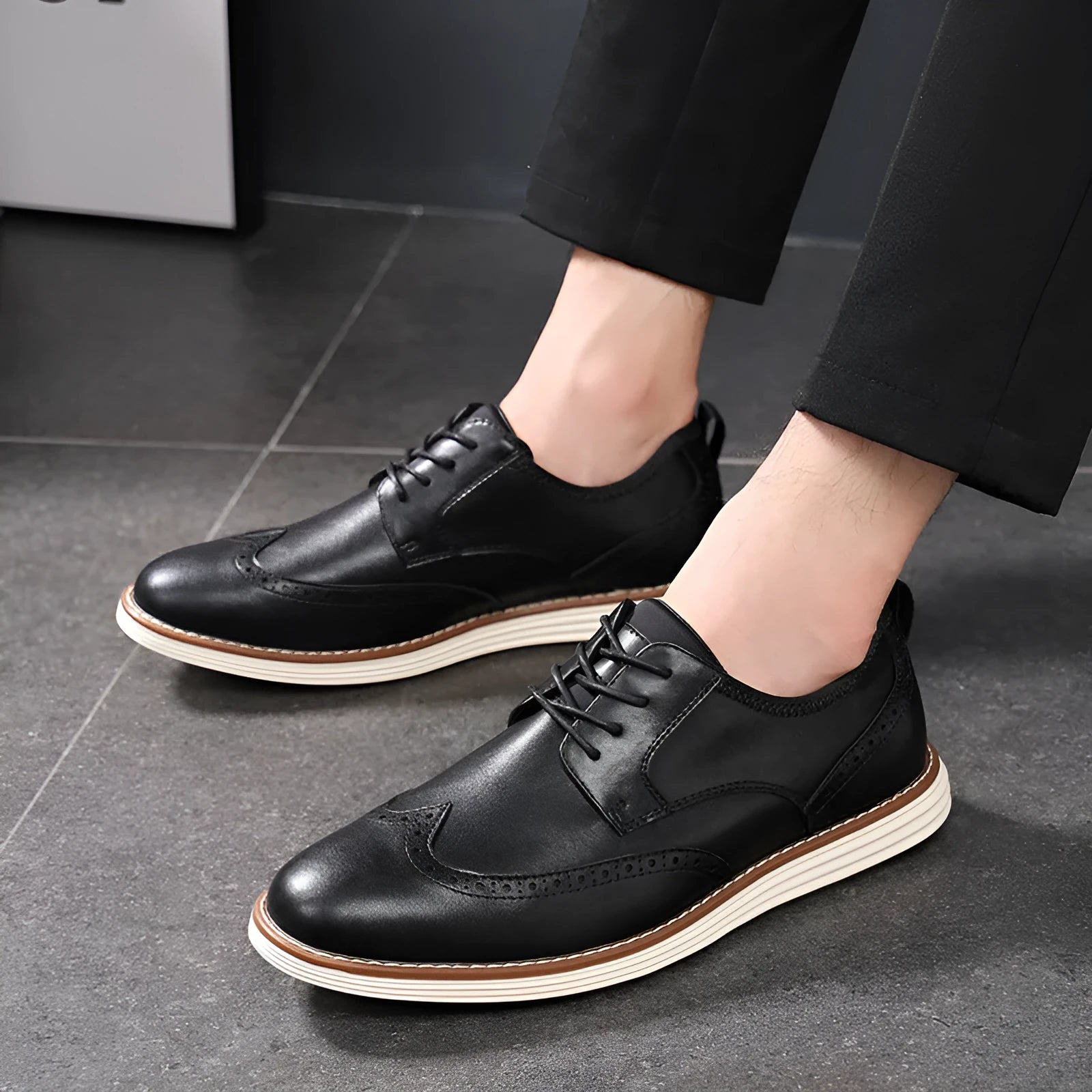 Men's black and brown slip-on business casual shoes with round toe and low top.