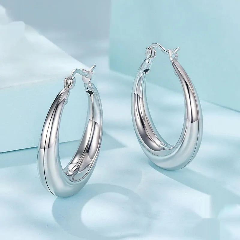Copper geometric ring clip-on earrings with silver needle detail in three sizes.