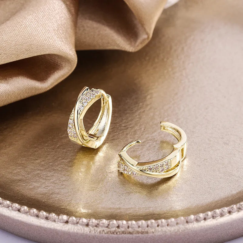 Geometric copper drop earrings with 14K yellow zircon treatment, showing structured shape and metallic finish