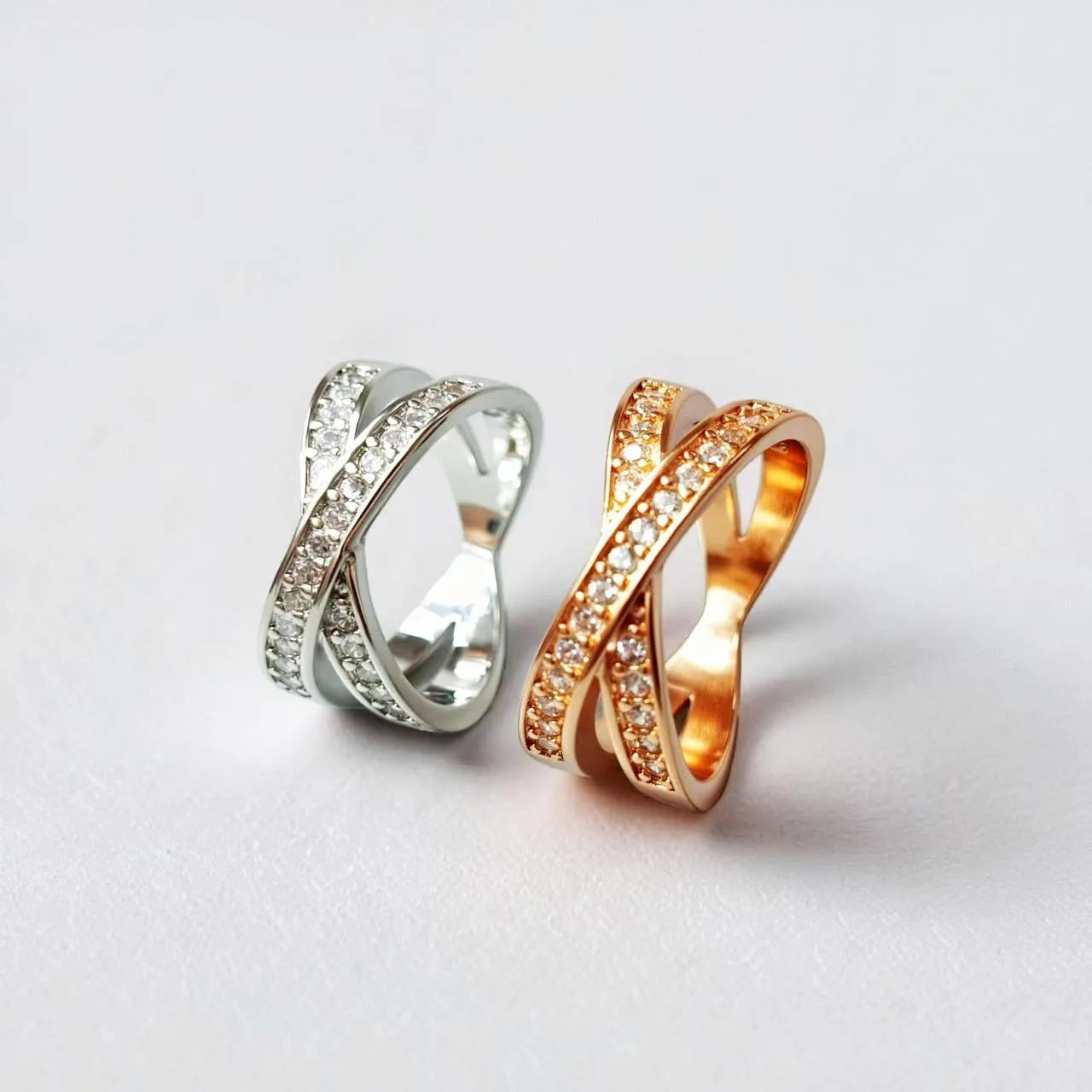 Silver cross ring with micro-inlaid zircon stones and geometric heart design on hand
