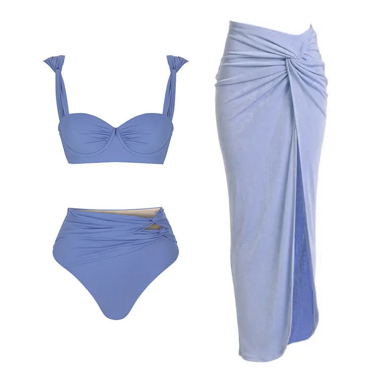 Women's solid colour one-piece swimsuit with gold buttons and a matching detachable skirt.