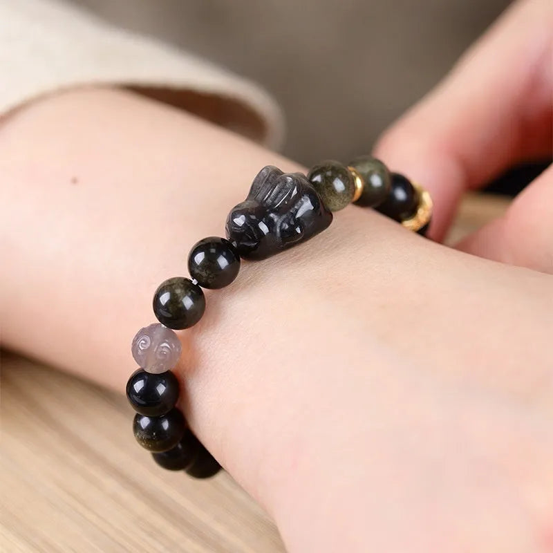 Handmade lying rabbit charm bracelet in Jin Yaoshi or Silver Yaoshi with 8mm or 10mm beads and grey agate accents.