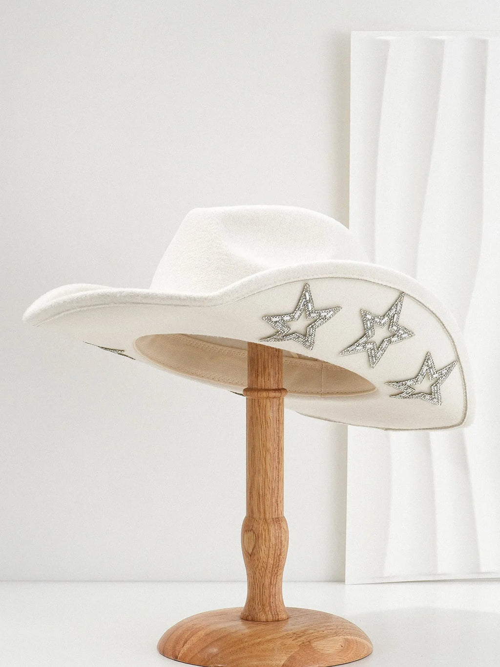 Beige polyester Western top hat with a conical crown and a silver hexagonal star decoration on the front.