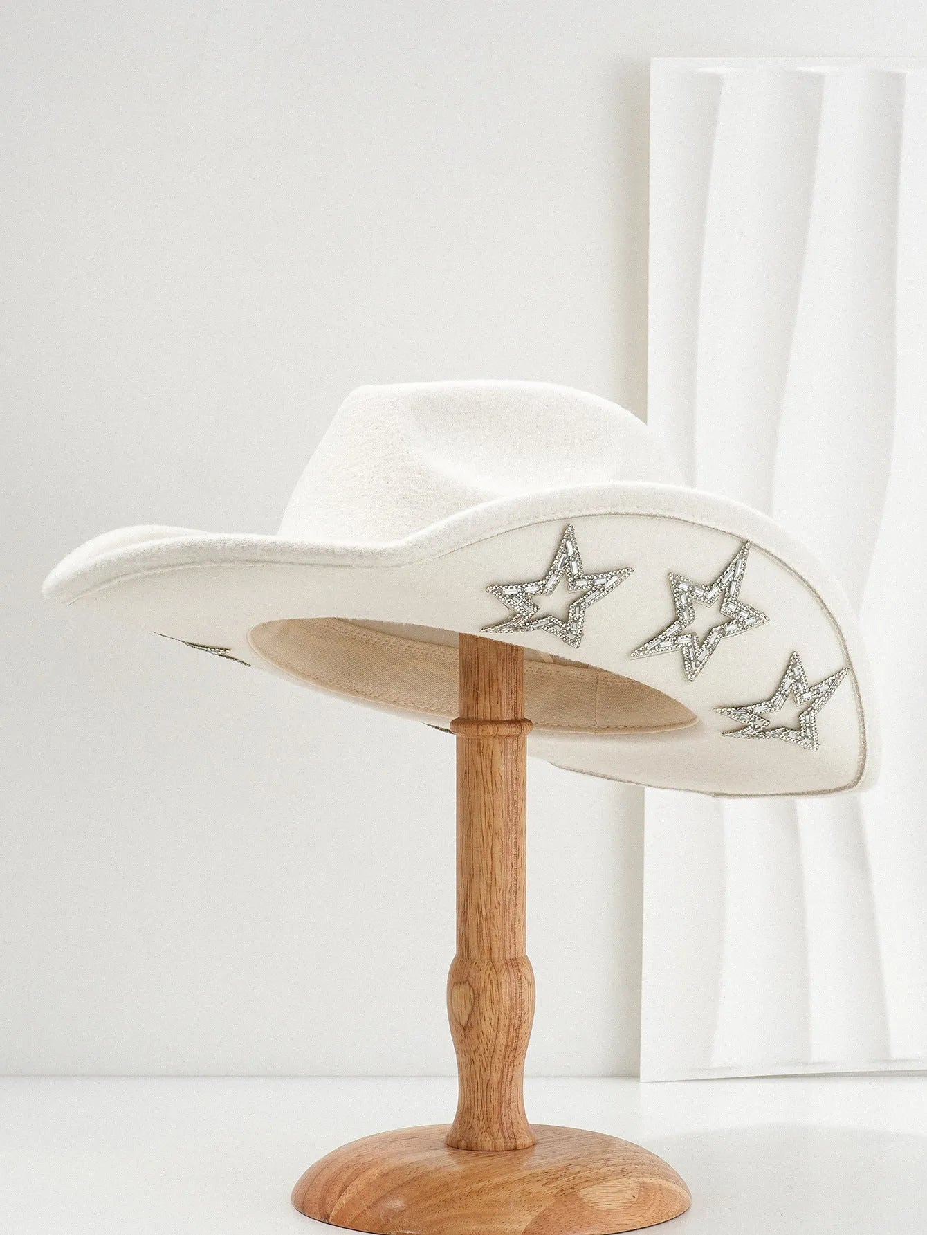 Beige polyester Western top hat with a conical crown and a silver hexagonal star decoration on the front.
