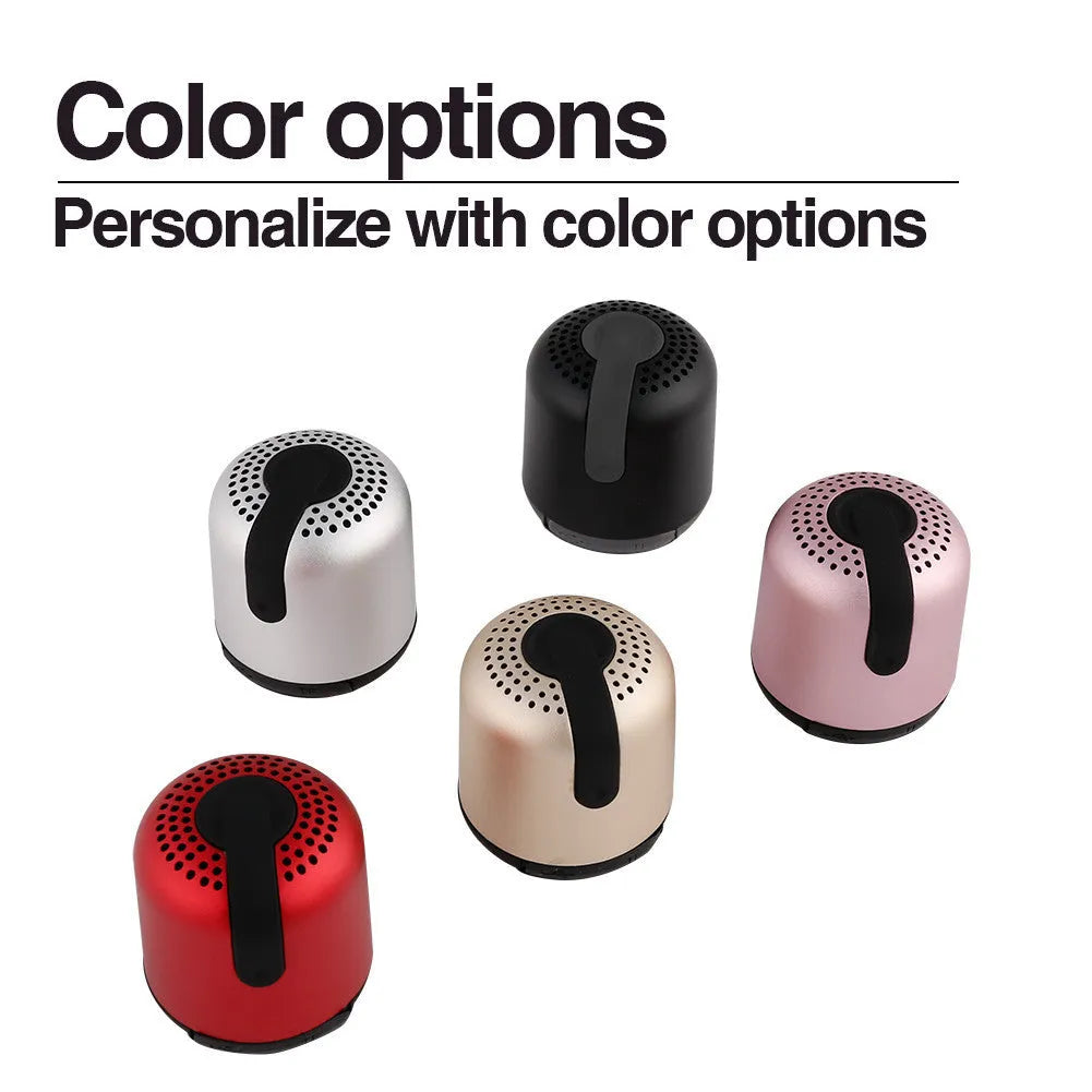 Hieha XQ11 cylindrical wireless Bluetooth speaker in silver colour on a table.