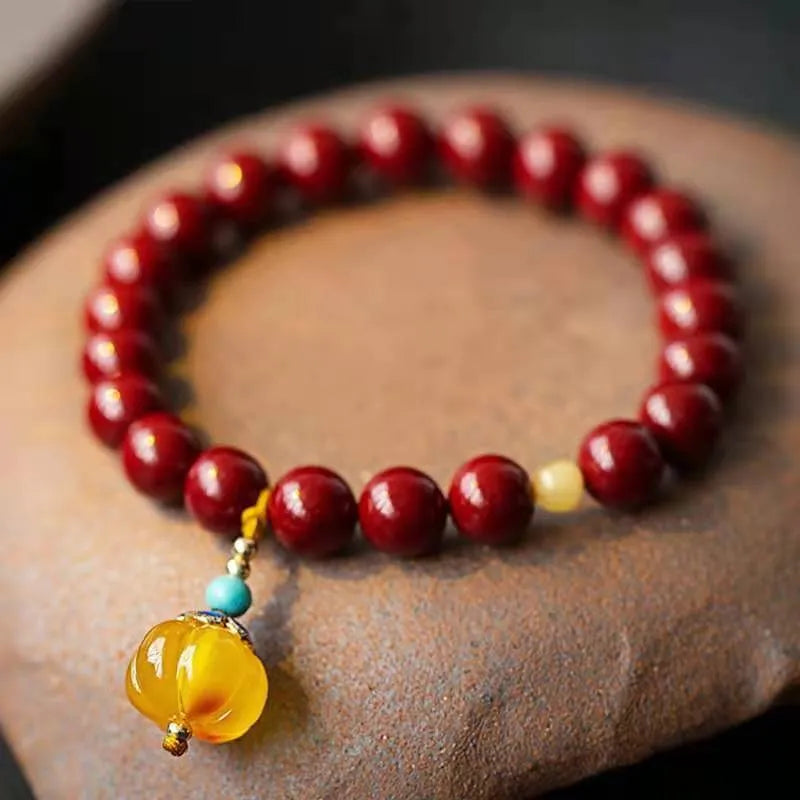 Handcrafted cinnabar bracelet with wave pattern design and copper bead accents in traditional Chinese style