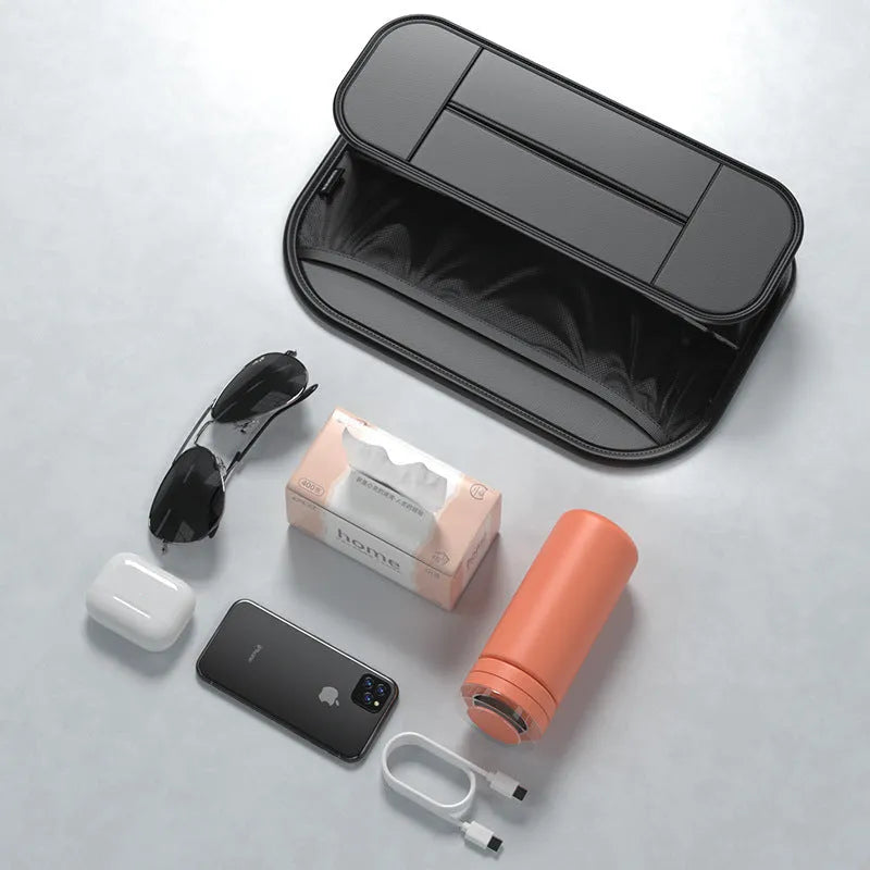 Black leather car seat back storage bag with mesh pockets for phones and bottles.