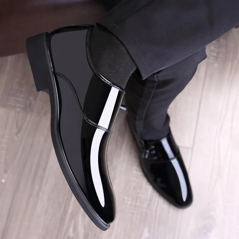Men's black formal slip-on shoes with a round toe and square heel on a rubber sole.