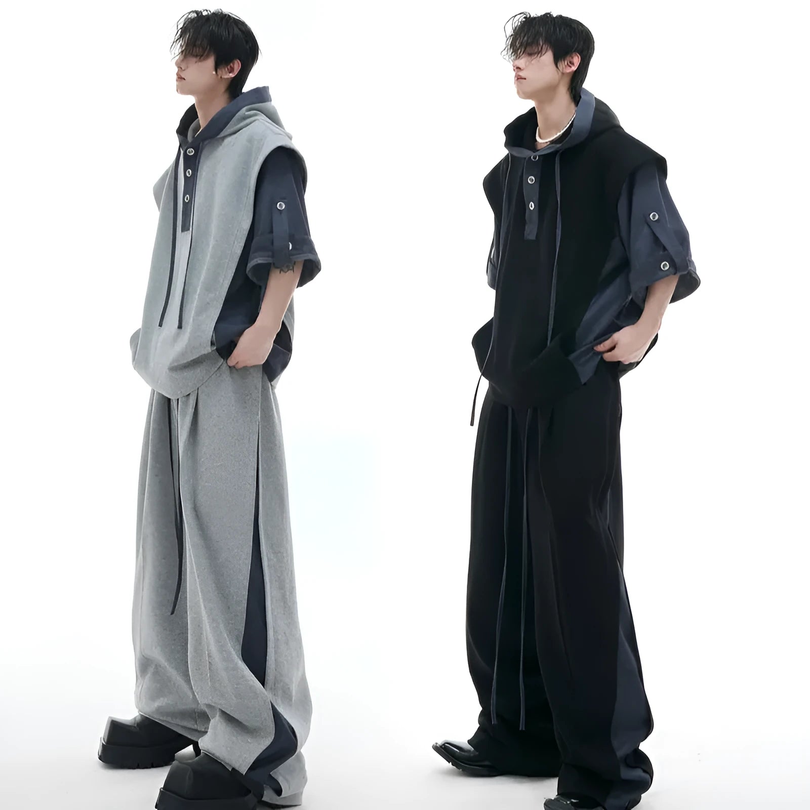Man wearing a black hooded short-sleeve jacket and matching trousers from a polyester leisure suit.