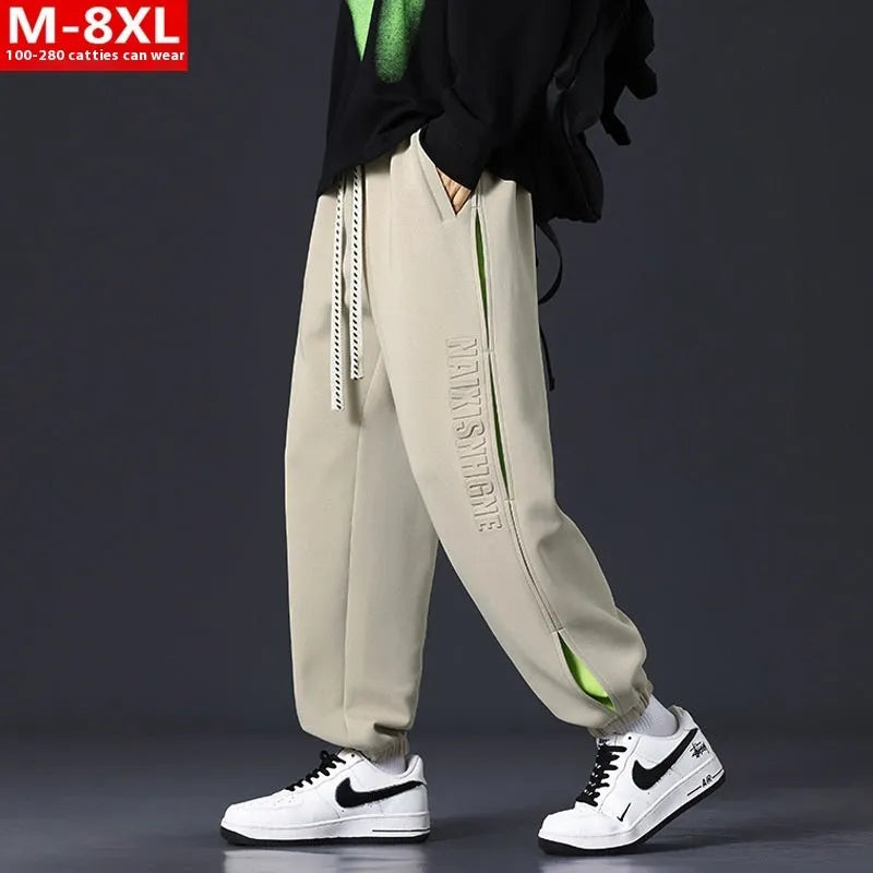 Men's grey green cotton casual trousers with white collage stitching detail and an elasticated ankle band.