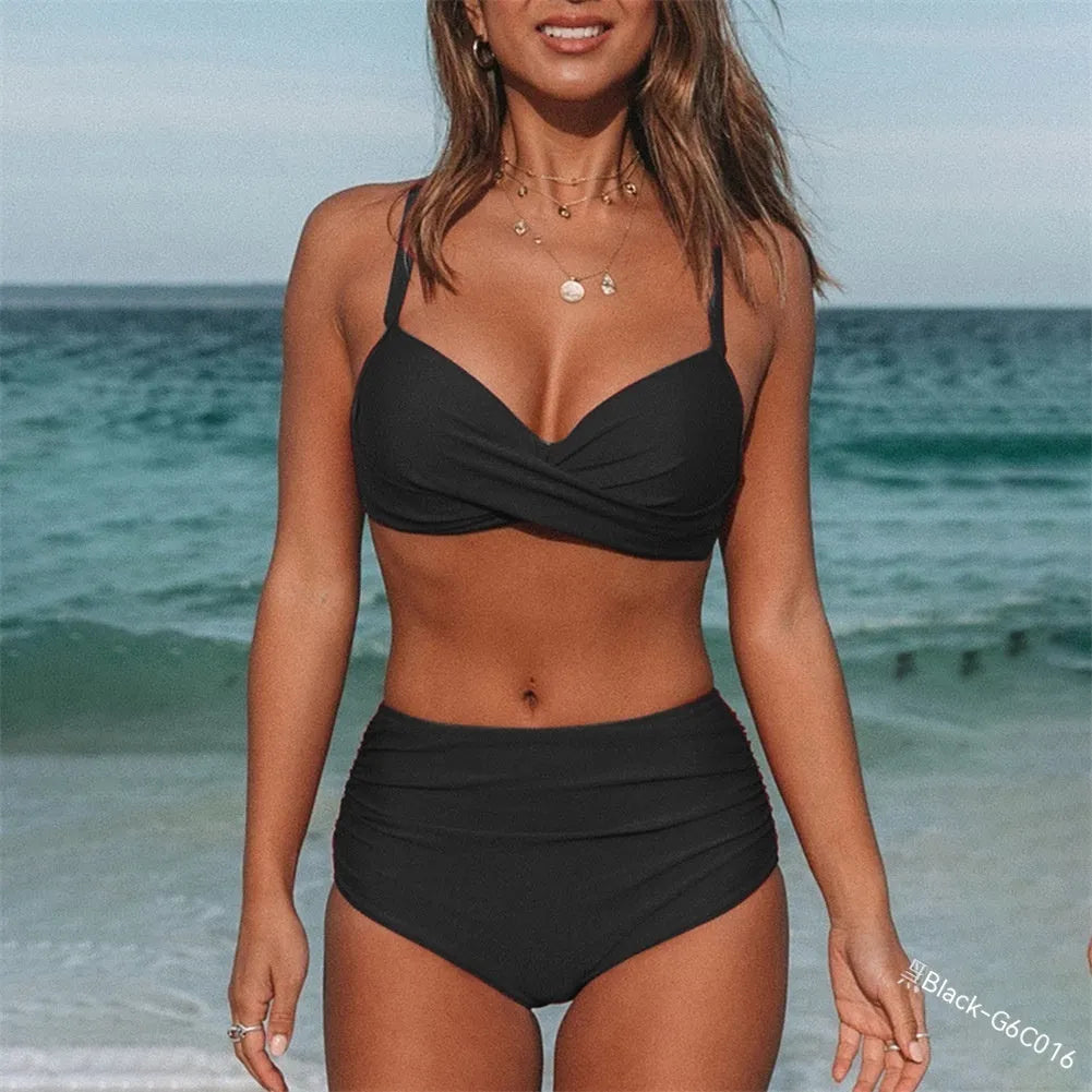 Women's solid colour cross-strap bikini swimsuit with removable cups on a mannequin.