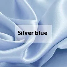 Pure silk duvet cover in a solid colour showing its sheen and texture, laid flat on a bed.