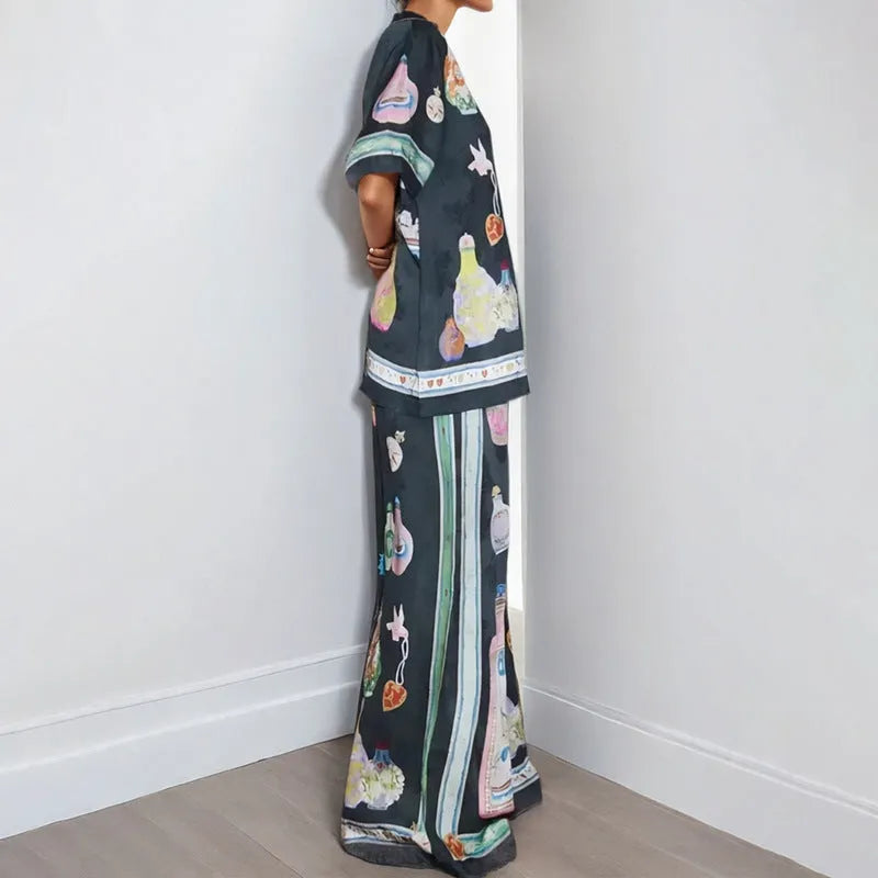 Black women's cardigan set with cartoon pattern, includes top with regular sleeves and matching trousers