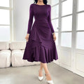 Purple women's long sleeve dress with round neck, mid waist, and ruffle detail on a hanger.