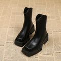 Black platform Martin booties for women with a square toe, back zipper, and a mid-calf height.