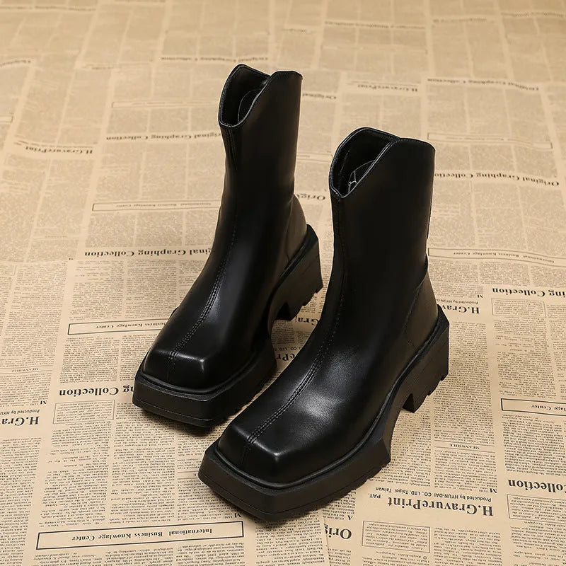 Black platform Martin booties for women with a square toe, back zipper, and a mid-calf height.