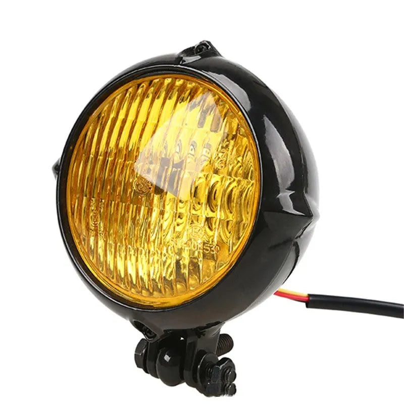 Black electroplated aluminium halogen headlight with 8cm diameter and yellow bulb.