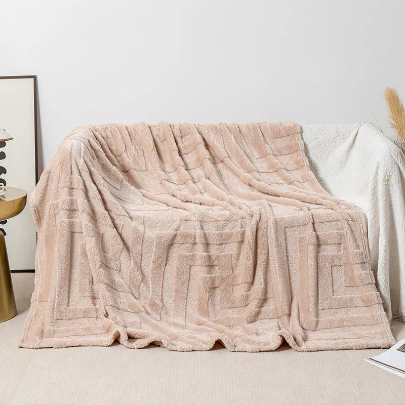 Thick coral fleece flannel blanket folded, showing solid green colour and soft texture.
