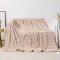 Thick coral fleece flannel blanket folded, showing solid green colour and soft texture.
