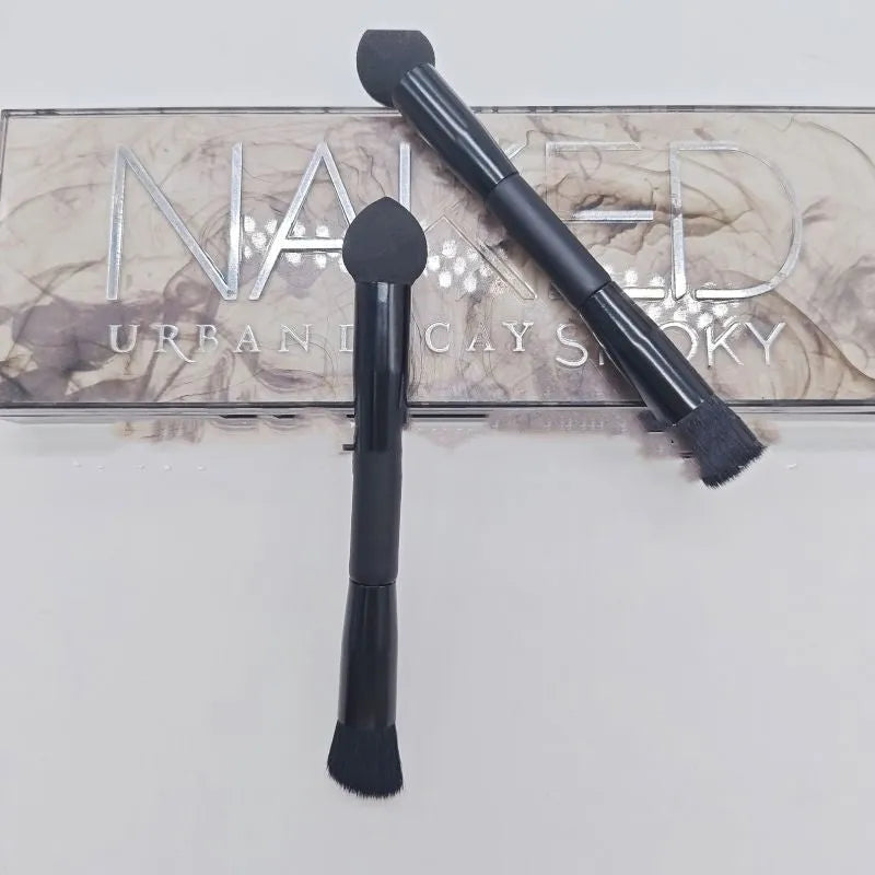 Black sponge-tip concealer brush with a wooden handle for covering dark circles.