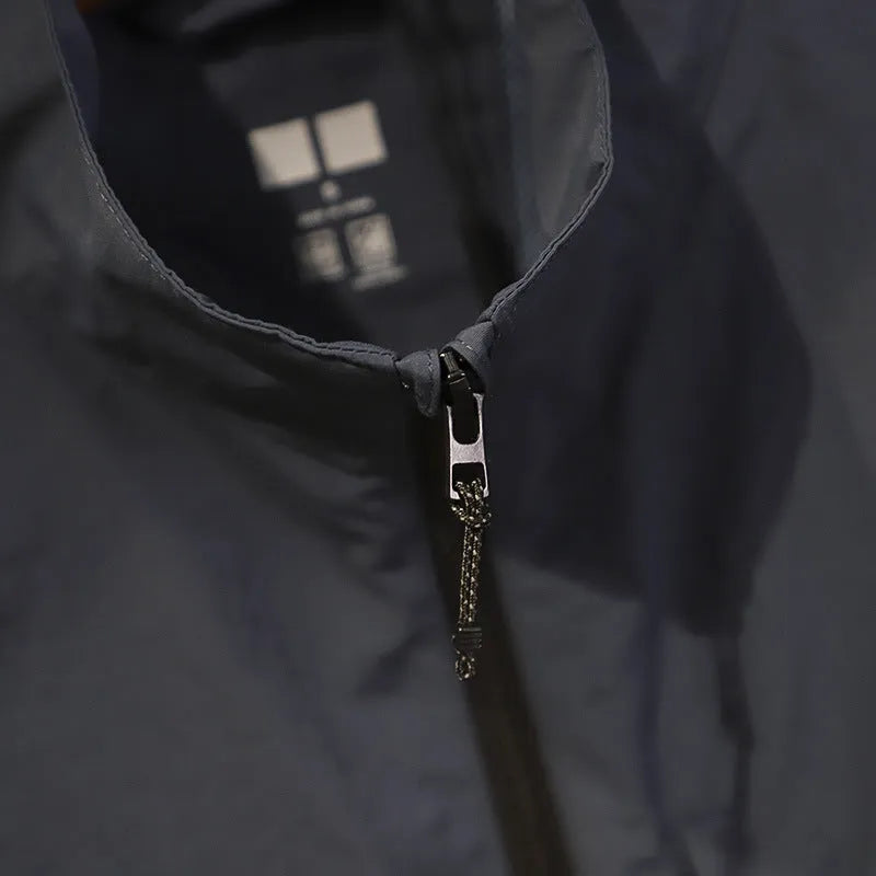 Men's straight cut nylon vest in army green with side seam pockets on a hanger.