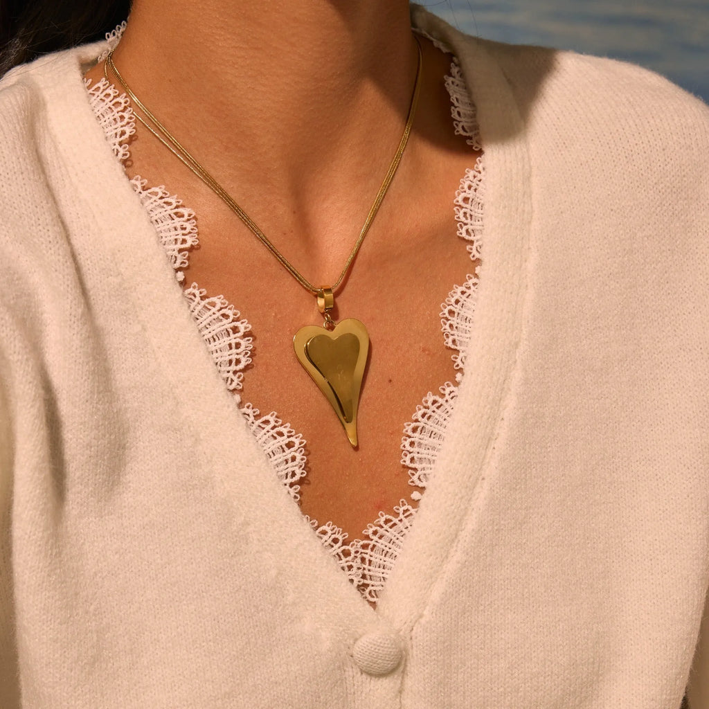 Women's stainless steel necklace with double heart geometric pendant on a snake bones chain in gold or steel finish.