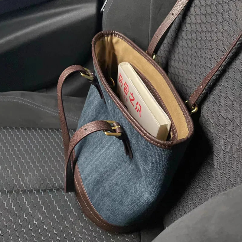 Denim patchwork bucket handbag with one-shoulder strap showing 23x27x16cm dimensions