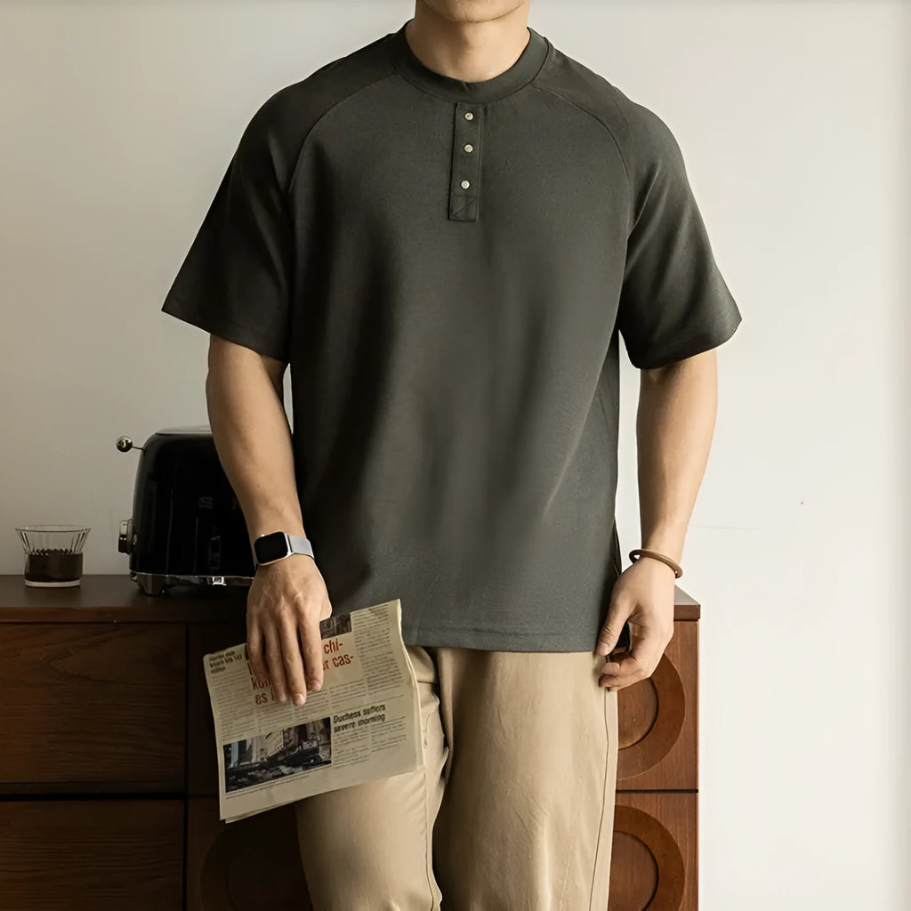 Casual loose-fitting grey pullover top with raglan sleeves and a textured terry fabric.