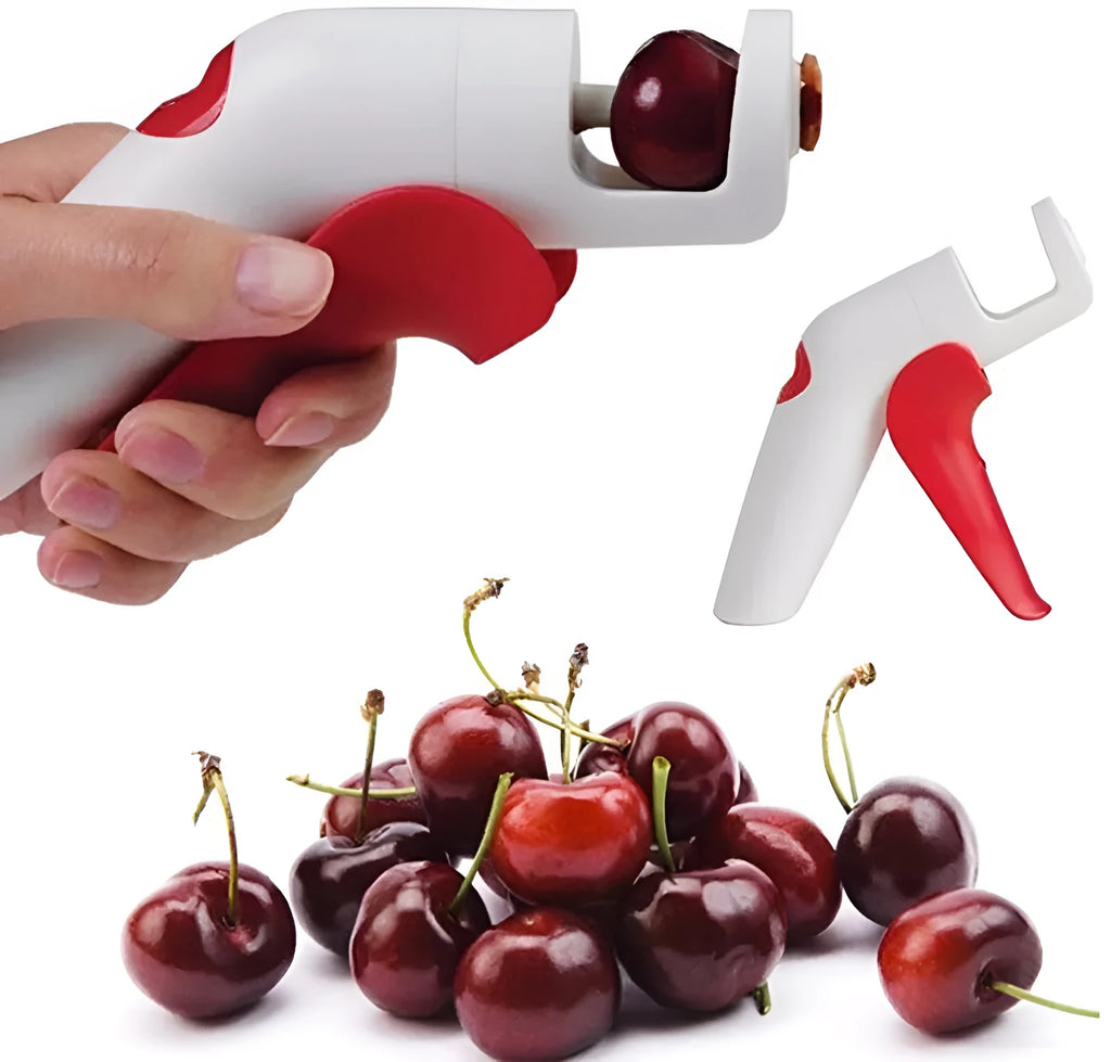 Stainless steel cherry kernel remover pitter tool on a kitchen worktop