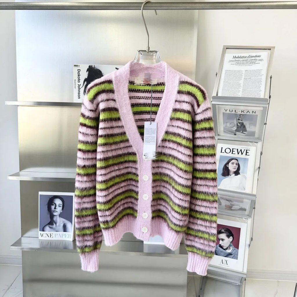 Pink women's wool knitted cardigan on a hanger, showing nap texture and regular sleeves.