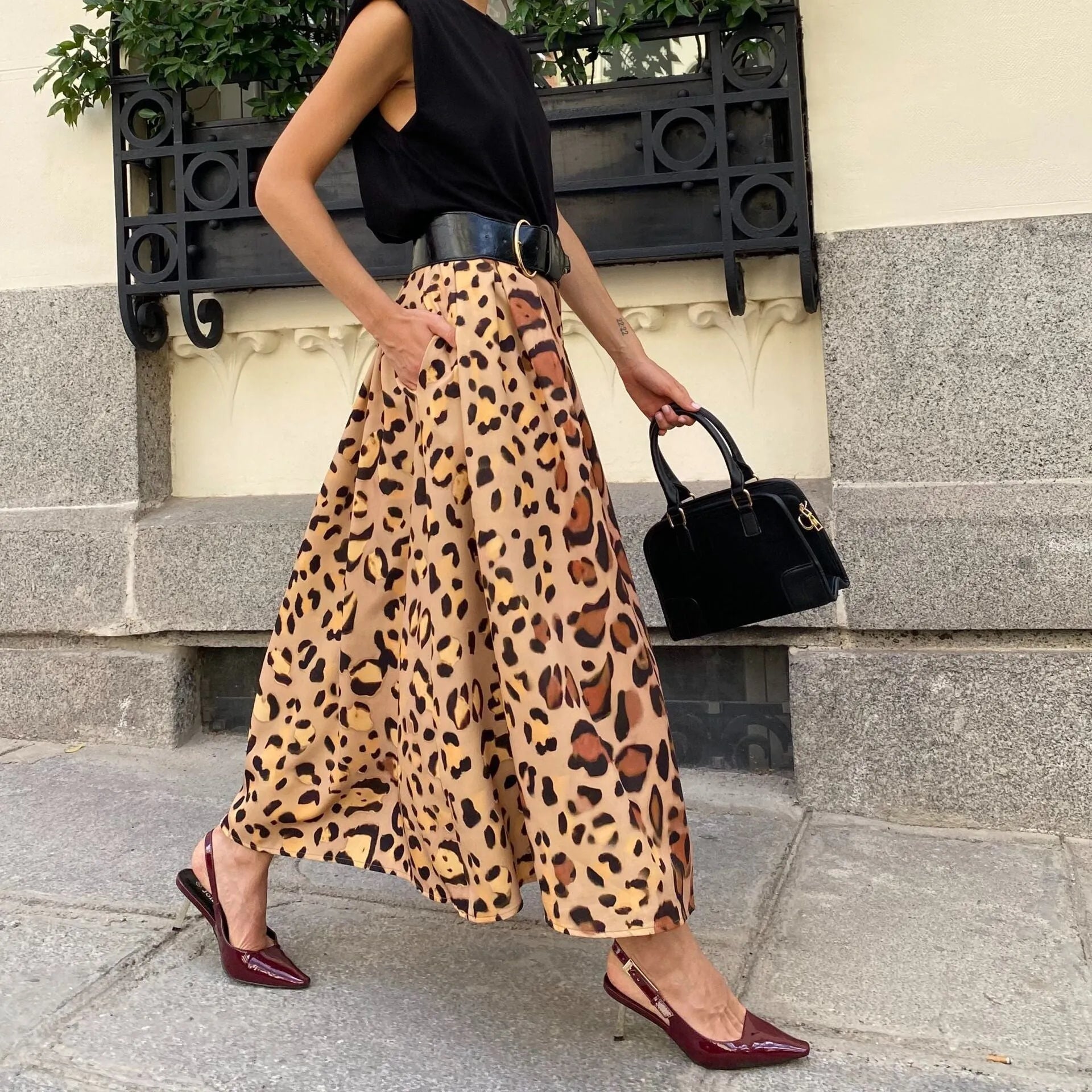 Brown leopard print women's A-line long skirt with elastic waistband on hanger