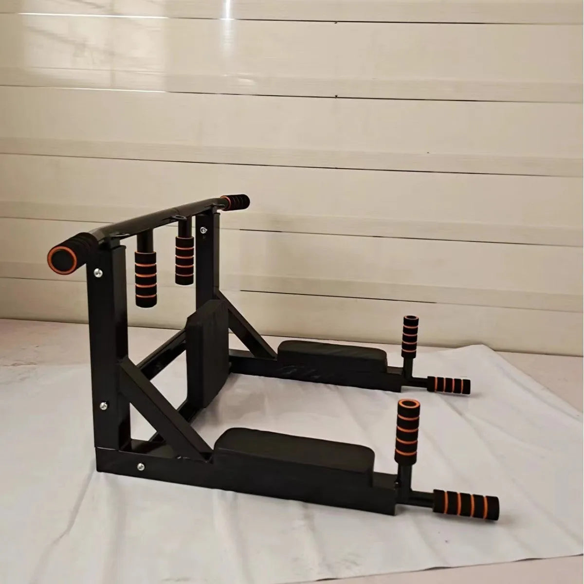 Black wall-mounted fitness equipment with integrated sandbag rack and parallel pull-up bars for indoor and outdoor strength training