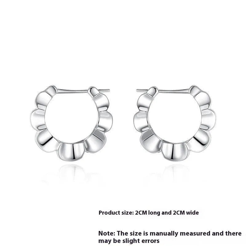 Pair of sterling silver geometric hoop earrings with round retro design elements