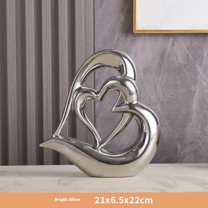 Modern white porcelain heart-shaped geometric ornament in a metallic gold finish.