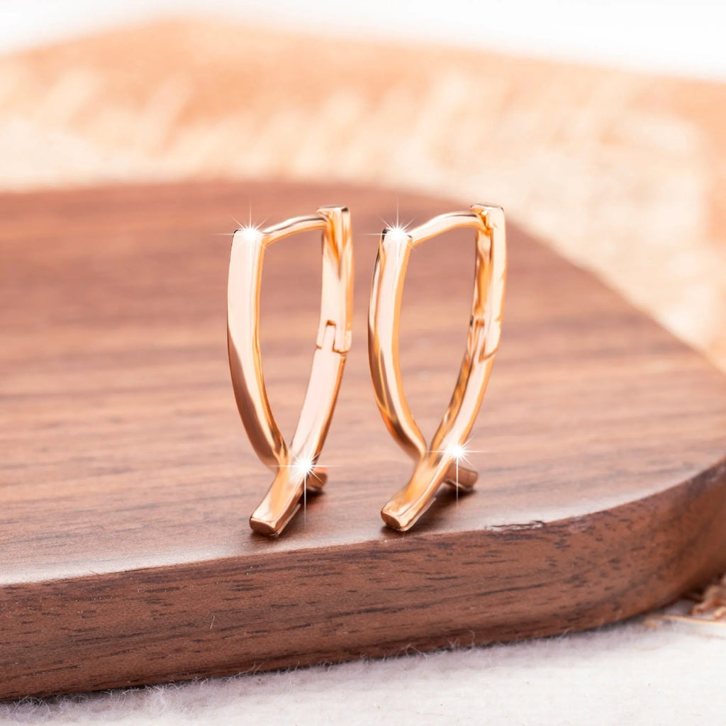 Cross shaped earrings in rose gold colour made from copper material