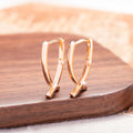 Cross shaped earrings in rose gold colour made from copper material