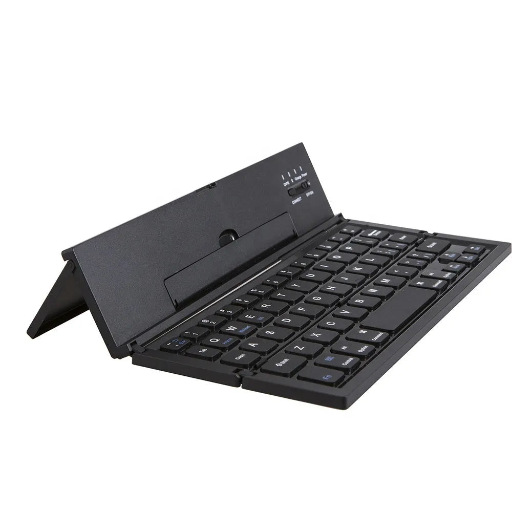 Black folding Bluetooth keyboard with numeric pad next to tablet