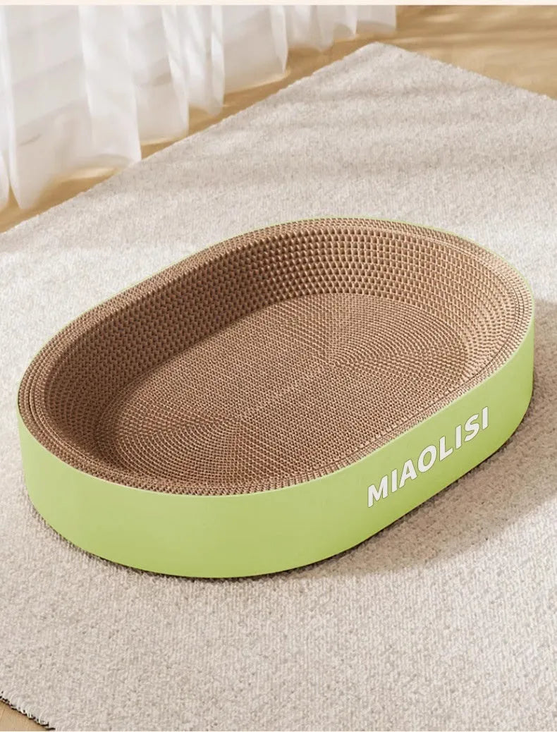 Green or purple oval corrugated paper cat scratch board and nest measuring 55cm in diameter