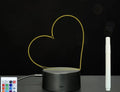 3D acrylic message board LED lamp lit up on a desk with remote control and marker pen.
