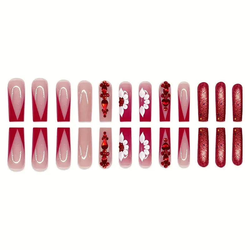 Long coffin shaped press-on false nails with red diamond gemstone and sweet flower pattern decoration.