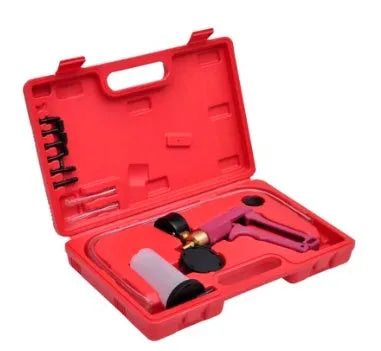 Manual aluminium alloy vacuum air blow gun suction tool for car repair on a workshop bench.
