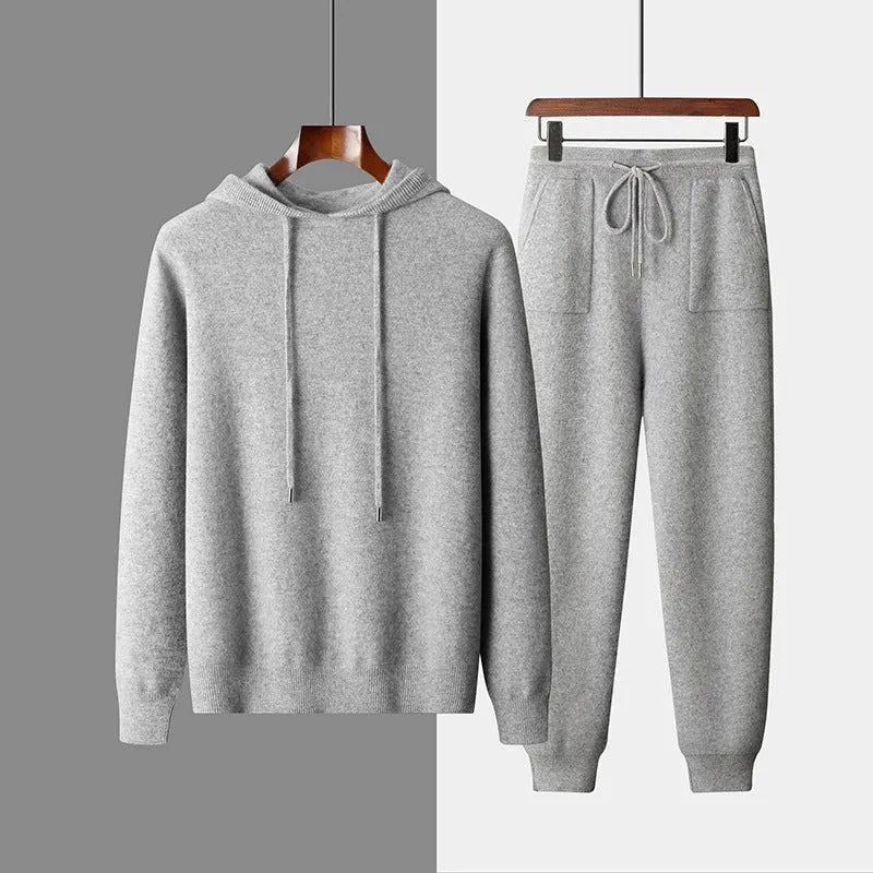 Men's light grey hooded cashmere sweatshirt and matching trousers laid flat as a complete casual set.
