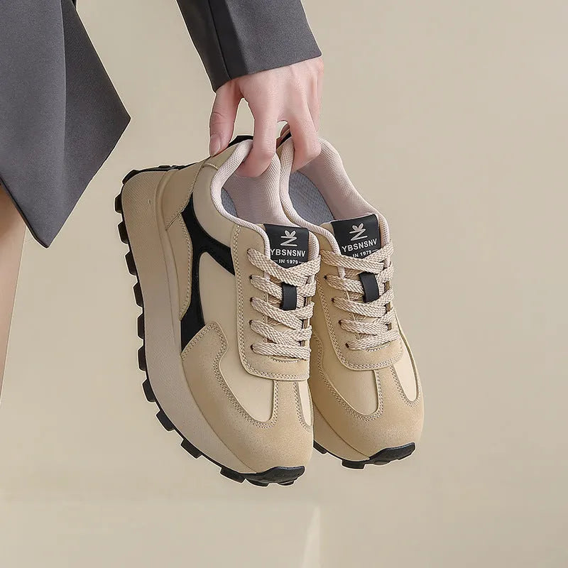 Women's solid colour low top sports shoes with flat platform heel and lace-up front.
