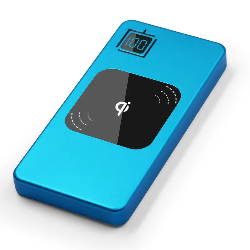 Silver portable power bank with LCD display showing battery percentage, placed next to a mobile phone.