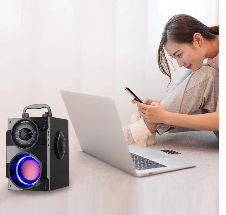 Black portable mini home audio system with subwoofer showing front speakers and connection ports