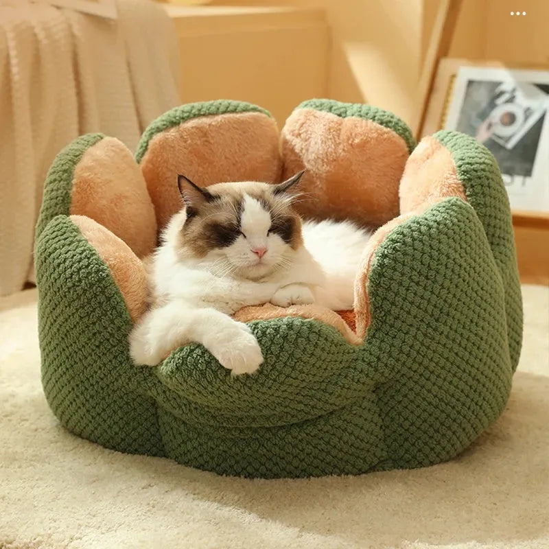 Green cactus petal shaped enclosed pet bed for cats and dogs on a hardwood floor.