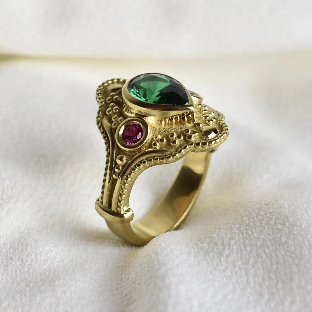 Geometric golden women's fashion ring on a grey background, showing its electroplated alloy construction.